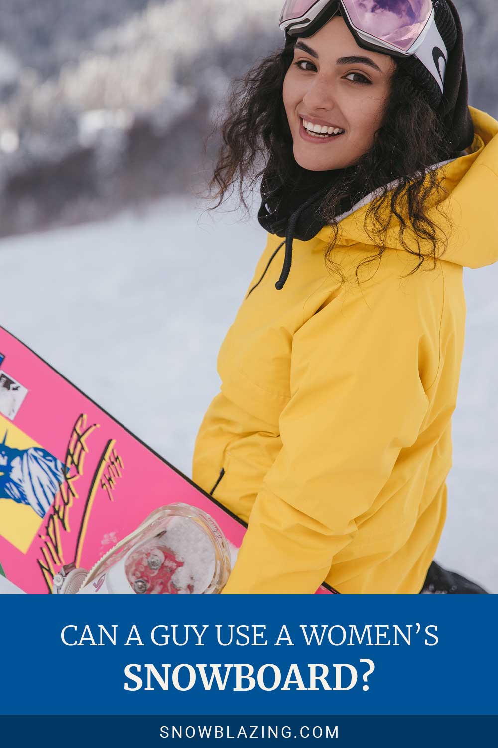 Woman in yellow jacket smiling with a snowboard in her hand - Can a Guy Use a Women’s Snowboard?